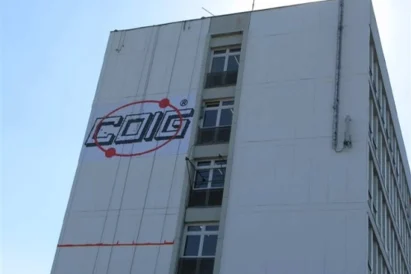 Wyklejanie szablonu loga na elewacji budynku przy wykorzystaniu technik alpinistycznych - Katowice