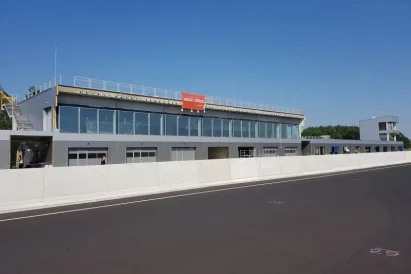 Wykonanie liter z aluminium i plexi oraz montaż napisu Porsche Driving Experience na fasadzie budynku